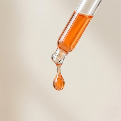 SknMaxxing facial serum dropper with orange liquid highlighting hyaluronic acid skincare product