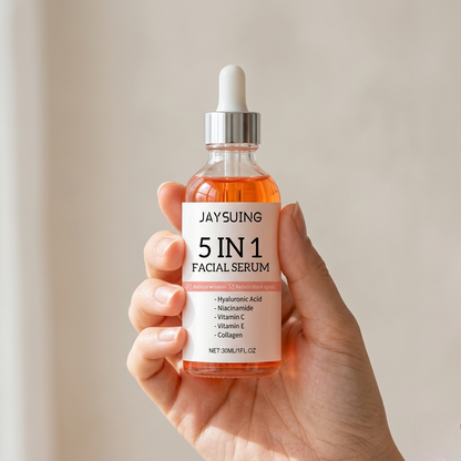 SknMaxxing facial serum bottle with hyaluronic acid held in hand showing 5 in 1 skincare benefits