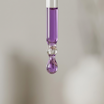 Close-up of purple liquid dropper containing niacinamide serum from SknMaxxing facial serum